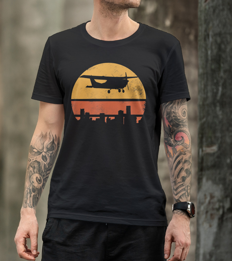 Retro Pilot C172 Flying Silhouette Over Sunset Cityscape T-Shirt
