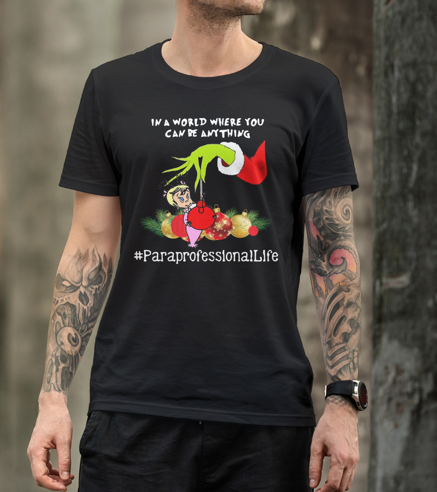 In A World Where You Can Be Anything Hand Grinch Holding Ornaments #ParaprofessionalLife T-Shirt