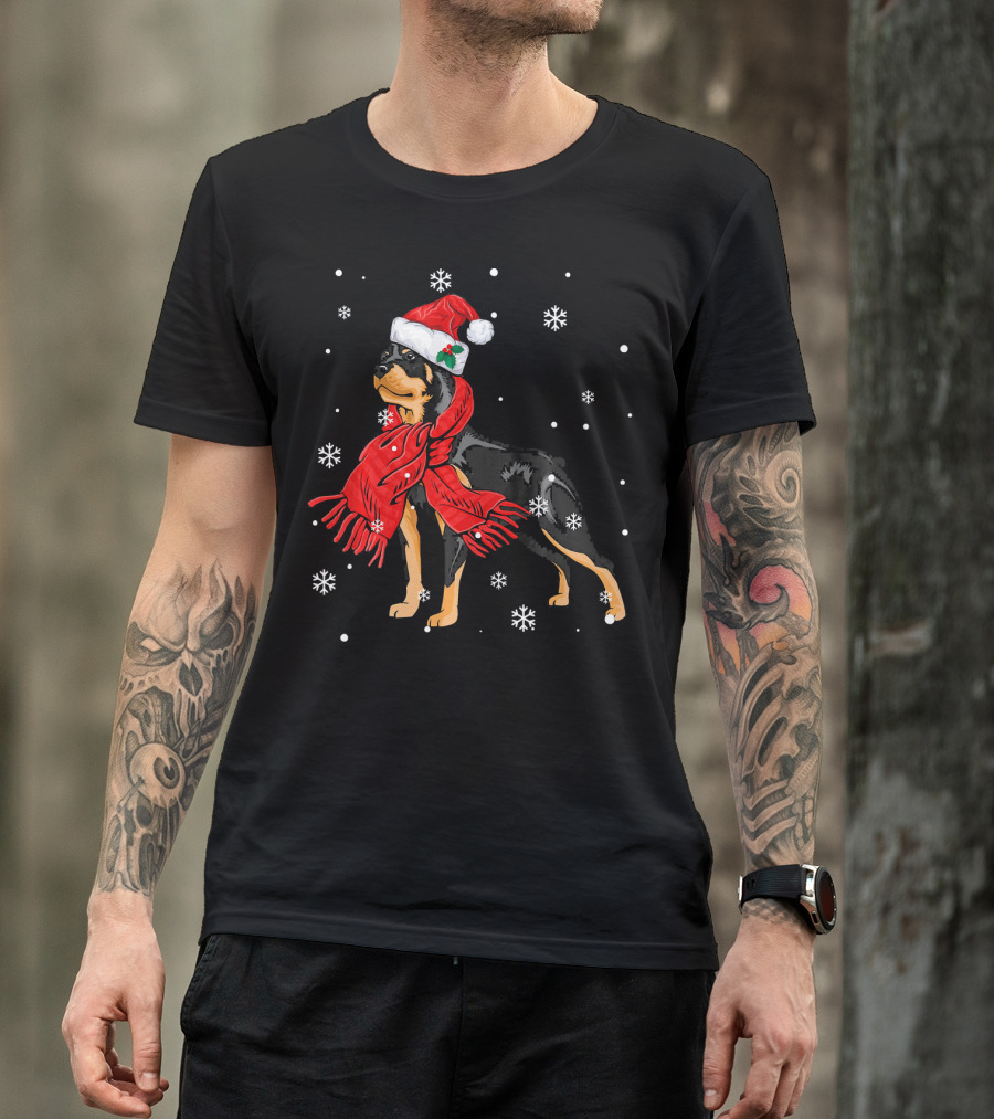 Rottweiler Wearing Santa Hat And Red Scarf Surrounded By Snowflakes T-Shirt