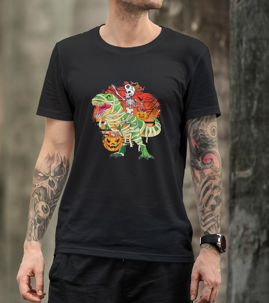 Skeleton Riding Mummy Dinosaur Rex With Halloween Pumpkins On Spooky Background T-Shirt