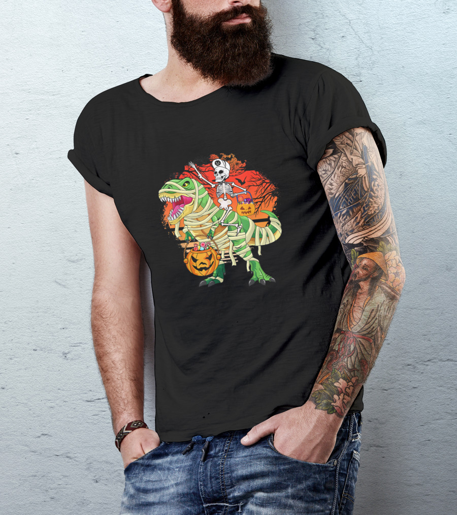 Skeleton Riding Mummy Dinosaur Rex With Halloween Pumpkins On Spooky Background T-Shirt