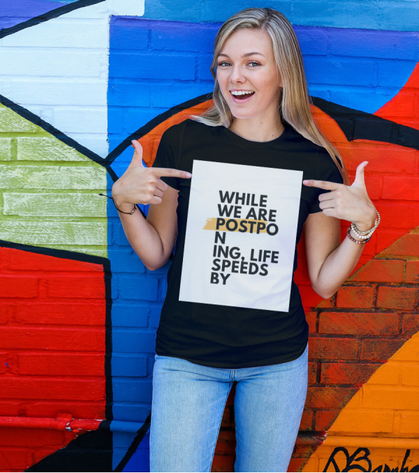 While We Are Postponing Life Speeds By T-Shirt