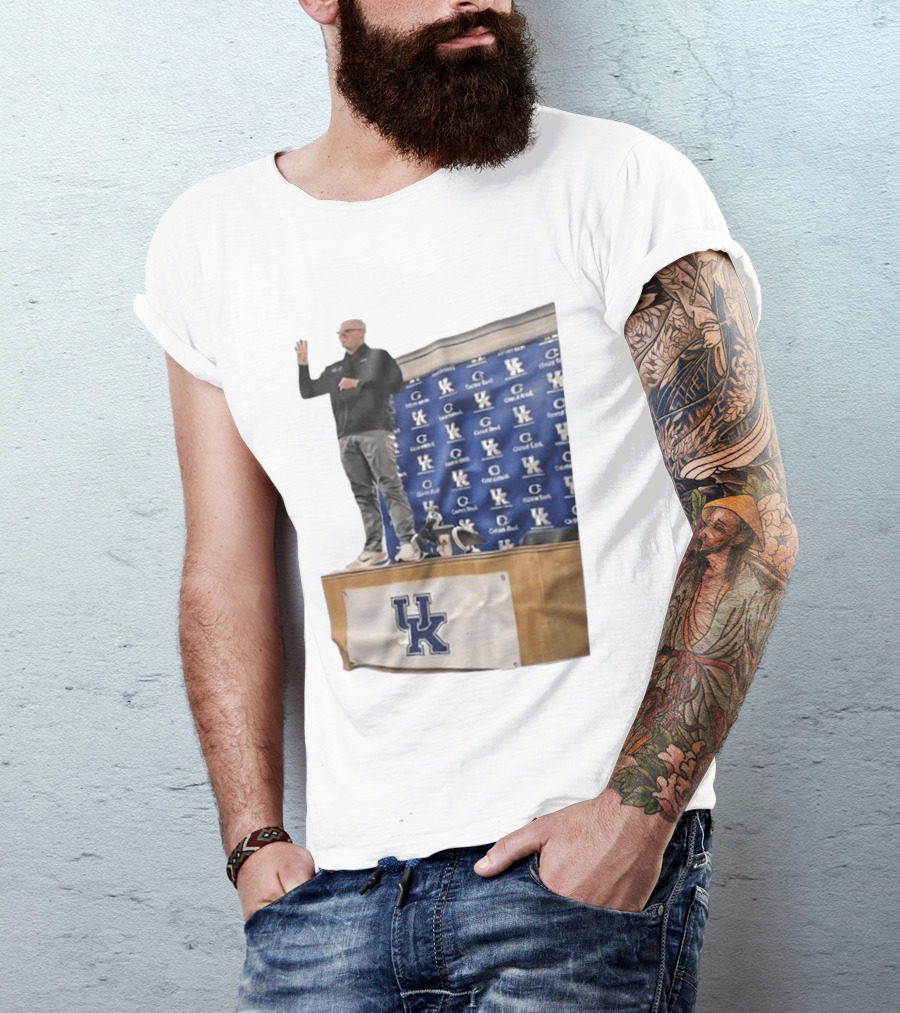 UK Volleyball Coach Craig Skinner Standing On Table With UK Logo And Awards T-Shirt