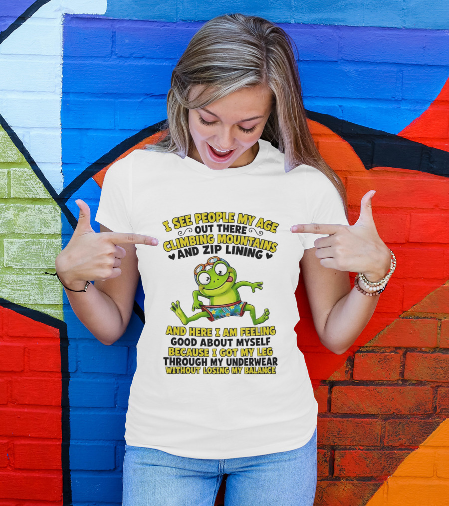 I See People My Age Climbing Mountains And Zip Lining Cartoon Frog Feeling Good Without Losing Balance T-Shirt