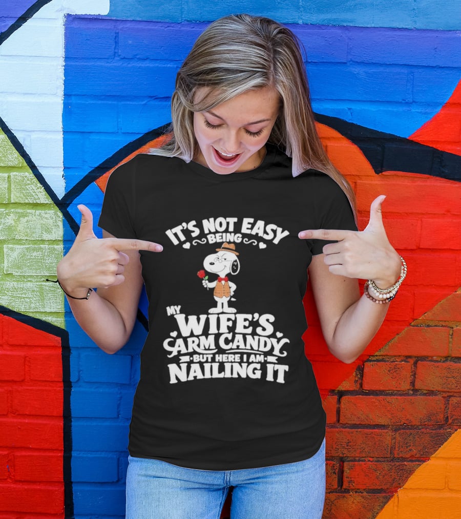 Snoopy It's Not Easy Being My Wife's Arm Candy But Here I Am Nailing It T-Shirt
