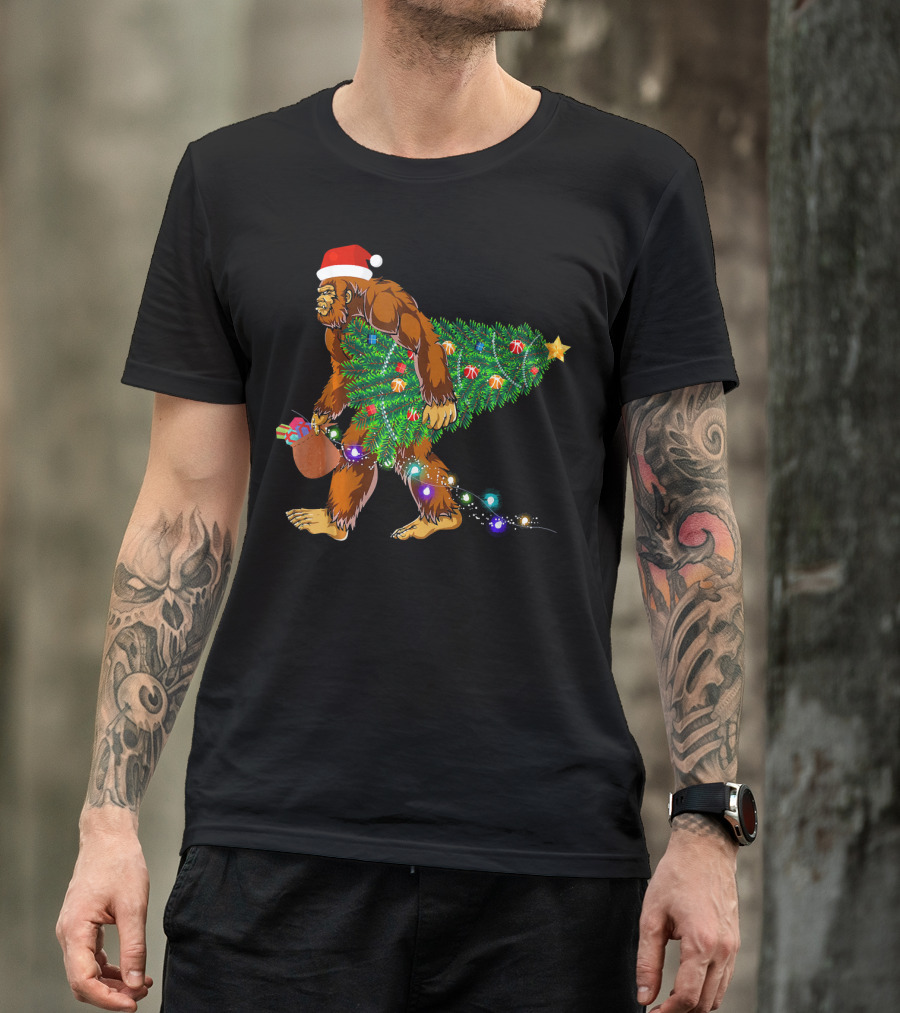 Santa Hat Bigfoot Holding Christmas Tree With Lights And Gifts T-Shirt