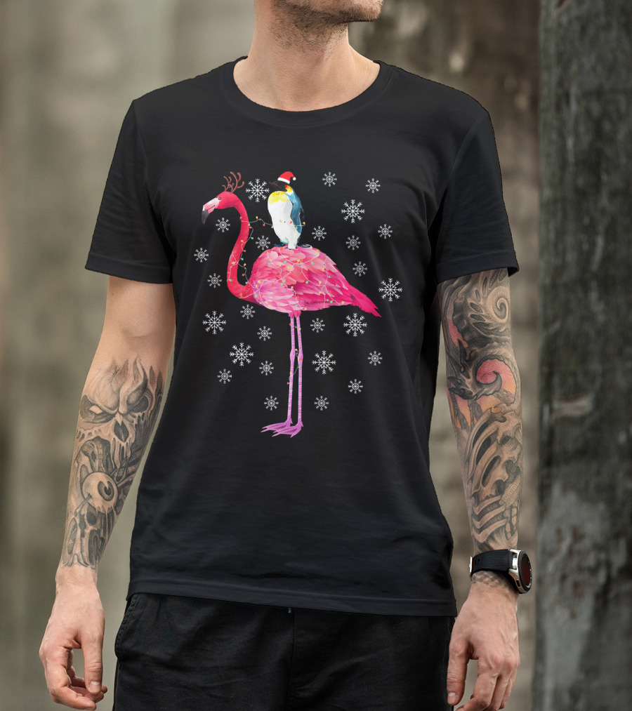 Penguin With Santa Hat Riding Flamingo With Antlers Surrounded By Snowflakes T-Shirt